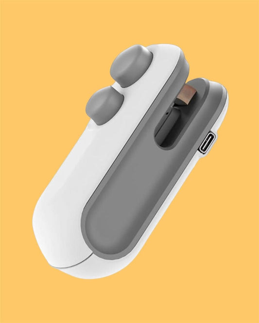 Compact white and grey handheld gadget heat sealer on yellow background from NayiDeals.