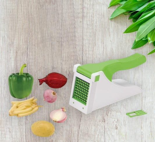 Vegetable chopper with green handle beside fresh bell pepper, potato, onion, and beans on wooden surface, NayiDeals kitchen gadget.