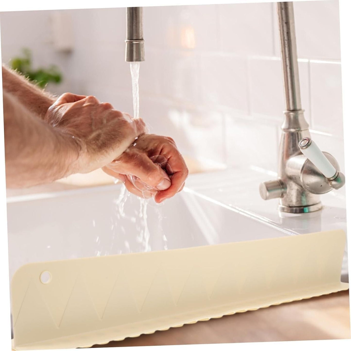 Man washing hands under kitchen faucet with silicone splash guard on sink, NayiDeals home gadget